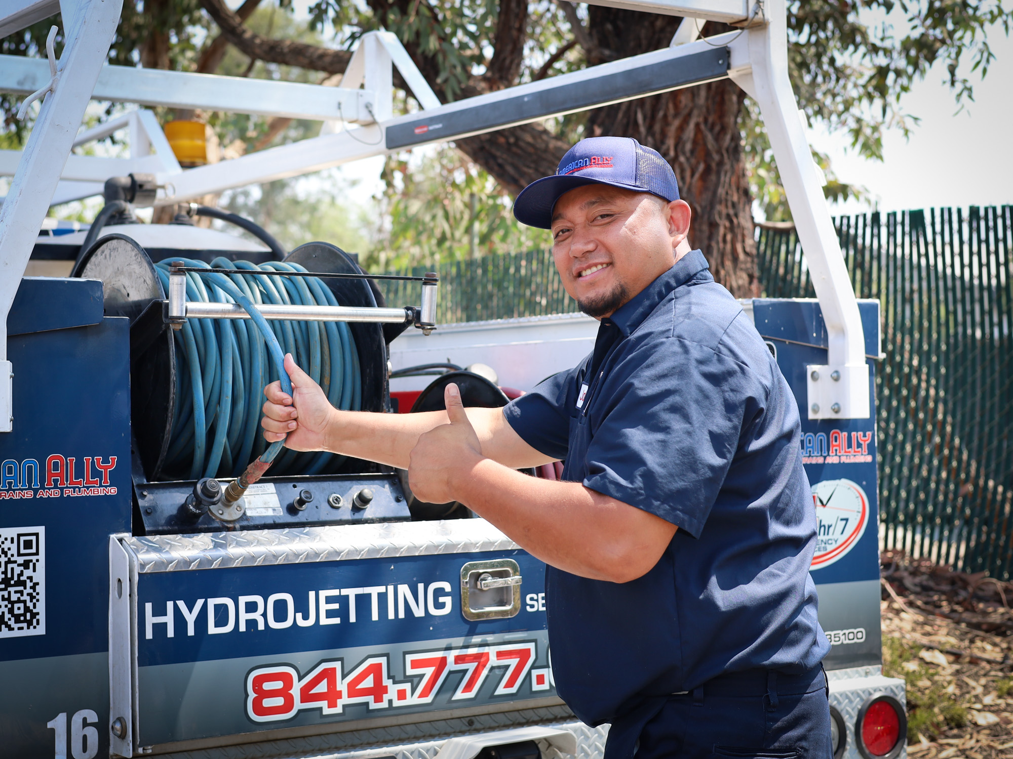 American Ally plumber giving thumbs up in front of service truck in Ramona, CA.